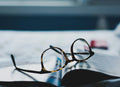 Tortoiseshell vintage-style sunglasses beside a magazine