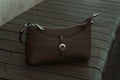 Brown vintage leather handbag on wood